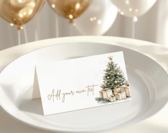 May include: A folded white card with a watercolor illustration of a Christmas tree and wrapped gifts. The card has the text "Add your own text" in gold script. Gold and white balloons are in the background.