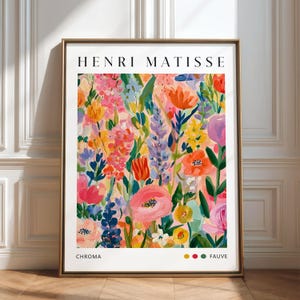 Könnte beinhalten: Ein gerahmter Kunstdruck mit einem lebendigen Blumenbild auf pfirsichfarbenem Hintergrund. Der Text HENRI MATISSE ist oben in Schwarz gedruckt, unten stehen CHROMA und FAUVE, begleitet von drei kleinen farbigen Kreisen in Gelb, Rot und Grün.