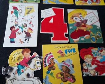 May include: A collection of vintage birthday cards and a large number 4. The cards feature illustrations of animals, children, and cowboys. Some cards have text that reads "Happy Birthday" and "Five Year Old!"