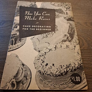 May include: A vintage book titled "Now You Can Make Roses" with a subtitle "Cake Decorating for the Beginner". The cover features black and white photos of cakes decorated with roses and other frosting designs. The price is $1.00.