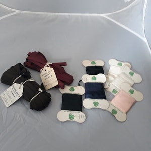 May include: Assortment of spools of ribbon in various colors, including burgundy, black, navy blue, white, and pink. Each spool is labeled with the Providence Braid Co. logo and the text "Sample".