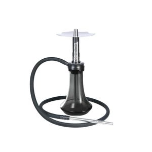 May include: A modern hookah with a black base and hose, and silver accents. The hookah has a clear, conical-shaped body and a silver metal stem. The hose is black and flexible, and the mouthpiece is silver. The text "SOCIAL SMOKE" is printed on the stem.