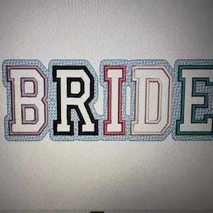 May include: Embroidered patch spelling out the word "BRIDE" in a varsity letter style. The letters are in various colors: pink, black, red, tan, and teal, each with a light blue border and a stitched texture.