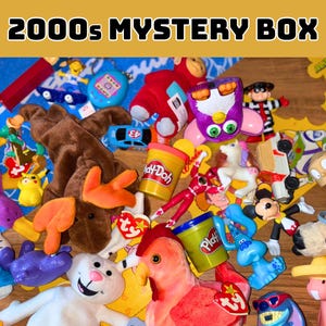 May include: A collection of 2000s era toys and collectibles, including plush animals, toy cars, Play-Doh, and various character figurines. The image features a variety of colors and textures, with the text "2000s Mystery Box" at the top.