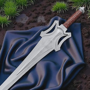 May include: A silver-colored sword with a brown leather-wrapped handle rests on a dark blue cloth. The sword has a distinctive design with a cross-guard and a pointed blade. The background features green grass and dark soil.