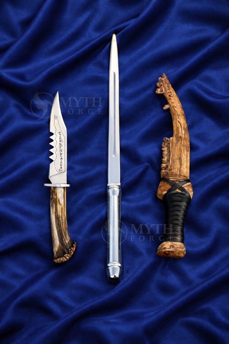 May include: Three handcrafted knives with unique designs. One has a serrated blade and antler handle, another is a long, slender blade with a silver handle, and the third has a wooden handle with leather wrapping.