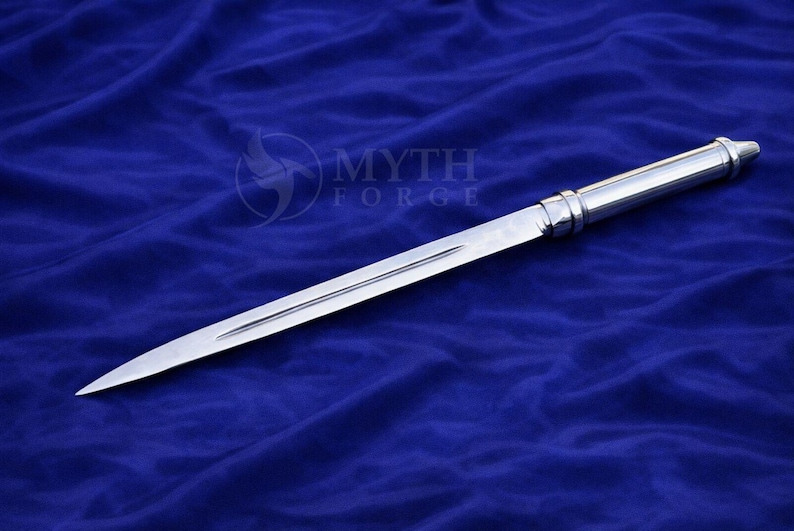 May include: A polished, silver dagger with a long, slender blade and a detailed handle. The dagger is displayed against a deep blue background. The text "MYTH FORGE" is visible in the upper right corner.