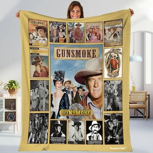 May include: A yellow Gunsmoke blanket featuring images of the TV show's cast and the show's logo. The blanket has a central image of a man in a cowboy hat, surrounded by smaller images and the words "GUNSMOKE".