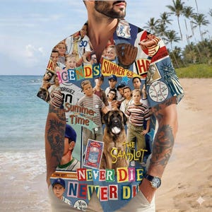 May include: A short-sleeved button-down shirt with a collage of images from the movie "The Sandlot." The shirt features baseball imagery, a large dog, and the text "Summer Time" and "Never Die." The background shows a beach scene.