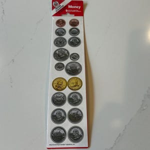 May include: A vertical sheet of stickers featuring realistic illustrations of various United States coins, including pennies, nickels, dimes, quarters, and dollar coins. The packaging is white with red accents and the text Money at the top.