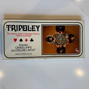 May include: A rectangular Tripoley board game box featuring the text The original game of Michigan Rummy Hearts and Poker, Includes CARDS, CHIPS and DELUXE LAYOUT, and CROWN EDITION NO. 225. The box displays card suit symbols and a game scene.