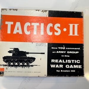 May include: Vintage Tactics II board game box. The box features a black tank illustration on a white background, with the title "TACTICS II" in large white letters on an orange background. The box also includes text that reads "REALISTIC WAR GAME by Avalon Hill."