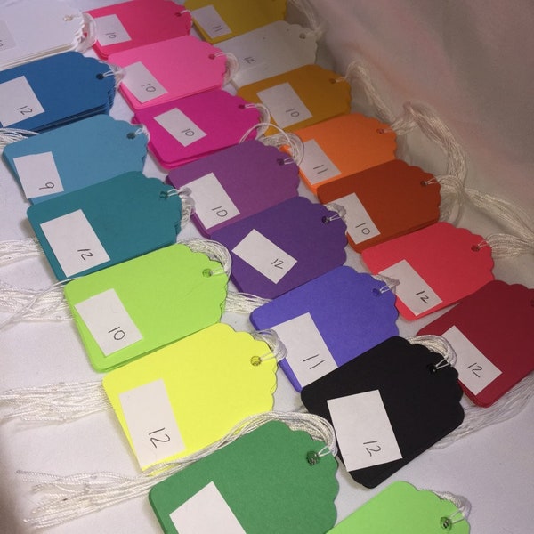 Rainbow paper prestrung tags. Handcut, tied and punched. Scrapbooking supply, gift tags, fancy item tags, cotton string