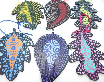 Wooden leaf ornament with abstract dot designs. Mandala painting leaves