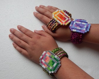 Crocheted retro pixel art cuff bracelets. Perler bead jewelry.