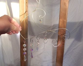 Suncatcher crystals with an abstract wire design hanger.