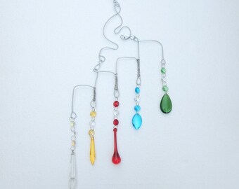 Suncatcher crystals with an abstract wire design hanger. Five elements, subtle Wicca design.