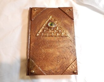 Illuminati Halloween prop occult spellbook, classic literature book, glass eye in the pyramid