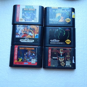 May include: Six Sega Genesis video game cartridges, including NHL All-Star Hockey, Flashback, Aliens, Light Crusader, and Judge Dredd.