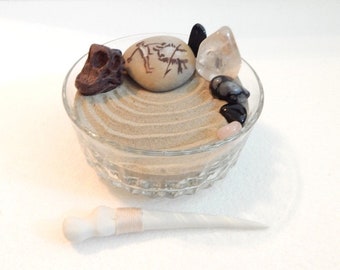 Primitive mini Zen garden in vintage glass dish. Dinosaur skull and mothman rock art.