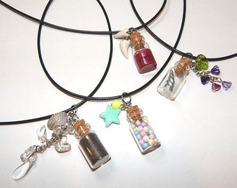Tiny bottle necklaces with several to choose from. Pastel gumballs, blood vial with fangs, unicorn horn with wistera, cat amulet.