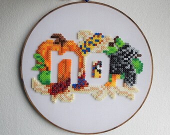 Funny Perler art wall hanging with Indian corn, crow, green apples and a pumpkin.