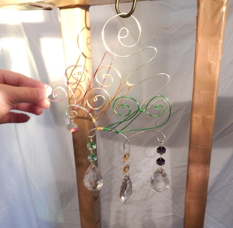 Suncatcher crystals with an abstract wire design hanger.