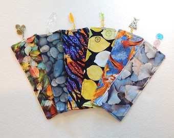 Quilted cloth bookmarks with bead embellishments.