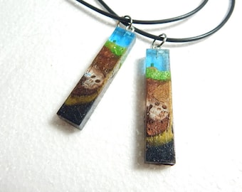 Skulls and carrots resin crystal pendant.