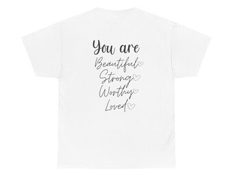May include: A white t-shirt with the words "You are Beautiful, Strong, Worthy, Loved" printed in black script. Small heart shapes are placed after each word. The shirt is made of a soft material.