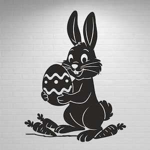 May include: Black silhouette of an Easter bunny holding a decorated egg, with carrots at its feet. The bunny has long ears and a smiling face. The egg has a wavy and dotted pattern.