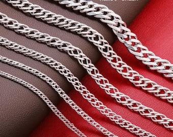 May include: A collection of silver-toned Rambo chains in varying thicknesses, arranged diagonally. Each chain features interlocking links with a polished finish. The text 925 Sterling Silver Rambo Chain is visible in the upper right corner of the image.