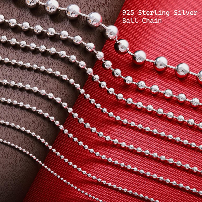 May include: A collection of 925 Sterling Silver ball chains arranged in parallel, ranging from thin to thick diameters. The silver beads are connected by small metal links, creating a continuous strand. The text 925 Sterling Silver Ball Chain is visible.