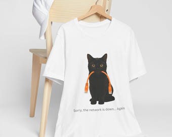 May include: White t-shirt featuring a black cat holding an orange Ethernet cable in its mouth. The cat has yellow eyes. Text on the shirt reads, "Sorry, the network is down... Again."