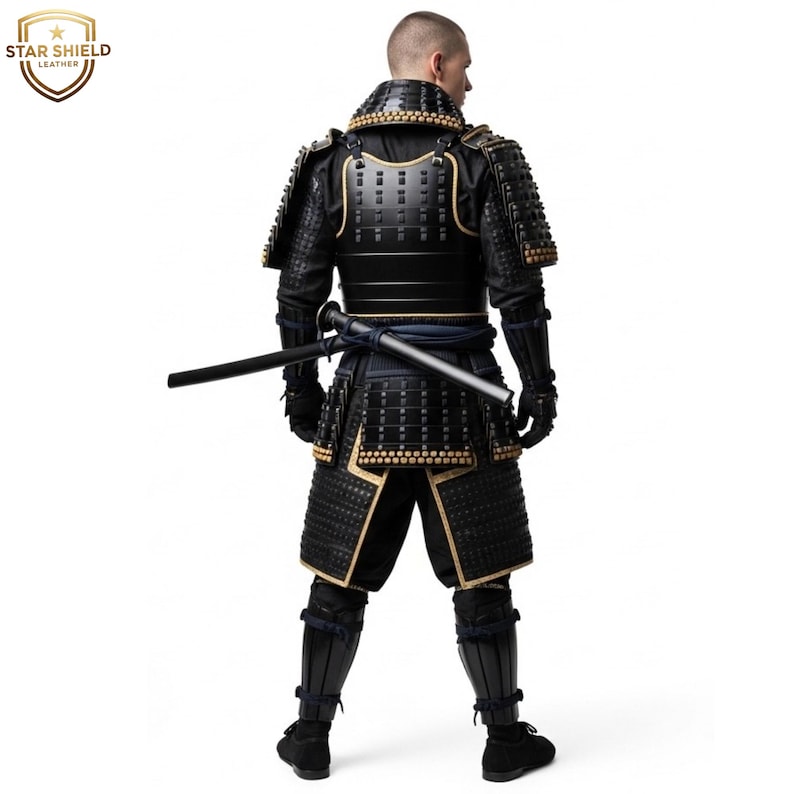 May include: Black and gold samurai armor with a katana. The armor features intricate detailing and a traditional design. The Star Shield Leather logo is visible in the upper left corner. The samurai armor is a full body suit.