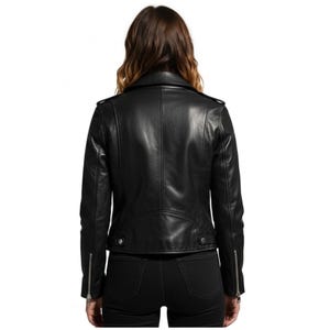 May include: Black leather jacket with a classic biker style. Features include a notched collar, asymmetrical zipper closure, and zippered cuffs. The jacket has a tailored fit and visible stitching details.