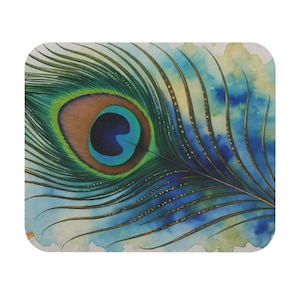 May include: A coaster with a watercolour illustration of a peacock feather. The design features a vibrant eye in shades of blue, green, and brown, set against a watercolour wash background. The coaster has rounded corners.
