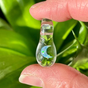 Petite moon opal pendant encased in clear borosilicate glass.  Pendant is handmade with love by The Flowing Crystall.