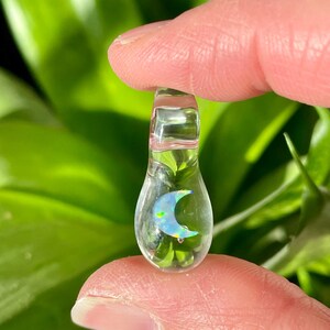Petite moon opal pendant encased in clear borosilicate glass.  Pendant is handmade with love by The Flowing Crystall.