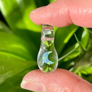 Petite moon opal pendant encased in clear borosilicate glass.  Pendant is handmade with love by The Flowing Crystall.