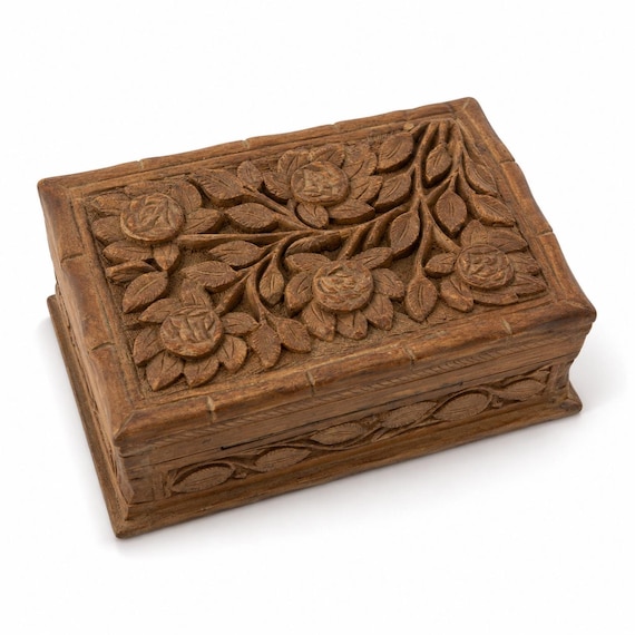 A hand-carved wooden puzzle box with a hidden opening mechanism — part functional keepsake, part tactile brain-teaser.