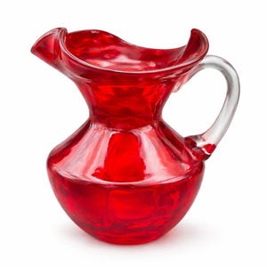 May include: A vibrant red glass pitcher with a clear handle. The pitcher has a flared, ruffled rim and a rounded base. The transparent glass allows the contents to be visible. This decorative pitcher is suitable for serving beverages.