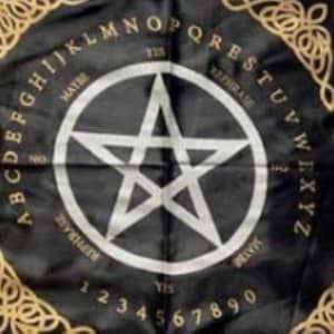 May include: Black fabric with a white pentagram in the center, surrounded by the alphabet, numbers, and phrases like "Yes" and "Maybe." Gold Celtic knot borders frame the design. A divination tool.