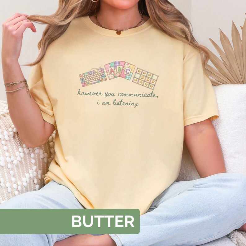 May include: Butter-colored t-shirt with a graphic of keyboards and the text "however you communicate, i am listening." The shirt also has the word "BUTTER" printed on the bottom.