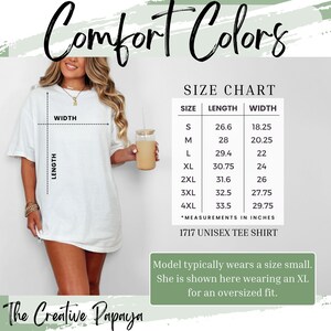 May include: A white unisex tee shirt with the text "Comfort Colors" in a script font. A size chart shows measurements in inches for sizes S to 4XL. The model is wearing an XL for an oversized fit. The Creative Papaya.