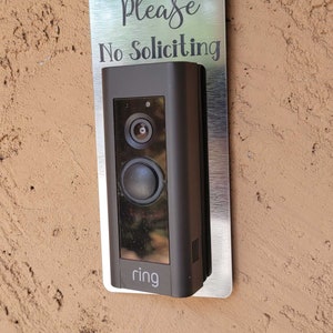 Ring doorbell with silver and black No Soliciting Sign
