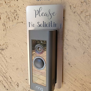 Ring doorbell with bronze and gray No Soliciting Sign