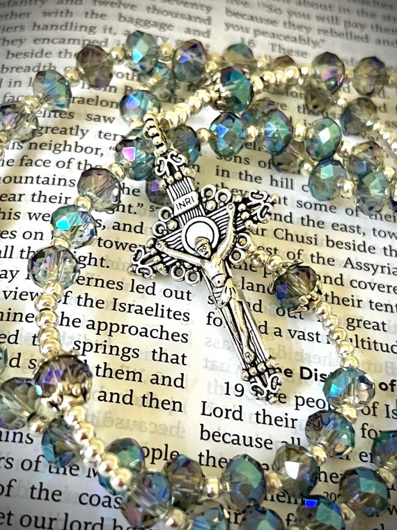 Handmade rosary with shimmering iridescent glass beads, silver accents, and a silver detailed crucifix