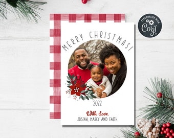 May include: A Christmas card featuring a family portrait inside a circular frame, with the words "MERRY CHRISTMAS!" above. The card includes the year "2022" and the message "With Love, Josiah, Marcy and Faith."