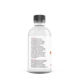 May include: A clear glass bottle with a black cap, containing a liquid. The label includes directions and ingredients, such as Organic Alcohol and Tea Tree Leaf Oil. The bottle is designed for skincare.